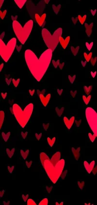 This mobile wallpaper showcases a beautiful pattern of red and pink hearts against a stylish black background