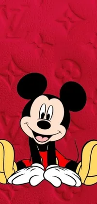 This lively phone wallpaper showcases the beloved cartoon character Mickey Mouse as he sits upon a bright red background surrounded by vivid digital art