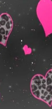 Looking for a striking phone wallpaper that exudes pink and black aesthetic vibes? Look no further! This live wallpaper features an array of hearts in black and pink colors that are set against a deep and dark background