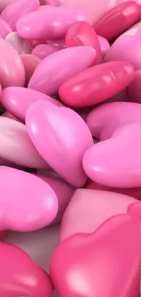 This phone live wallpaper showcases a delightful arrangement of pink and white hearts on a white surface, resembling a sweet shop or candy store