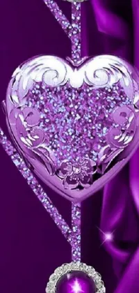 This live wallpaper features a heart-shaped object adorned with sparkling diamonds against a soothing purple background