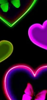 This live phone wallpaper features a striking black background adorned with an array of colorful hearts and green neon signs that flicker in an enchanting manner