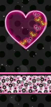 This lively phone wallpaper features a bright pink heart atop a black polka dotted background