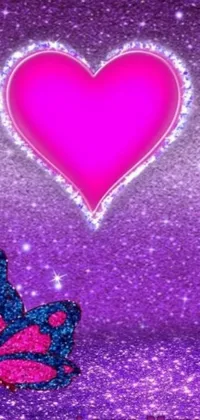 This live phone wallpaper displays a charming, colorful scene featuring a beautiful butterfly perched on a glittery pink and purple heart