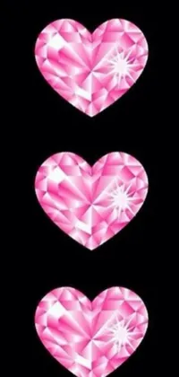 This stunning live wallpaper features three pink hearts adorned with diamonds against a black background