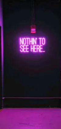 Looking for a trendy live wallpaper for your phone? Look no further than this eye-catching and interactive design! Featuring a neon sign that reads "nothing to see here," this wallpaper is perfect for fans of neon noir aesthetics