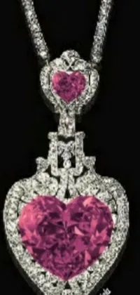 This phone live wallpaper features a pink heart-shaped diamond pendant on a chain that sparkles and glitters