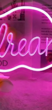 Introducing a striking phone live wallpaper, featuring a bold neon "dream" sign set against a black backdrop