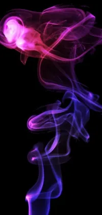Looking for a mesmerizing phone wallpaper? Check out this stunning digital art piece featuring smoke on a black background! In shades of purple and pink, this wallpaper will cast a colorful spell on your screen
