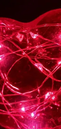 Enhance your phone's screen with this stunning live wallpaper featuring a heart-shaped red light, iridescent wiring, and a vibrant color scheme