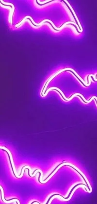 This phone live wallpaper features a closeup of a neon sign with bats on it, made of liquid purple metal