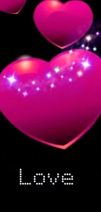 This phone live wallpaper features two pink hearts floating amidst a vibrant Hurufiyya-inspired background