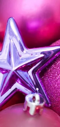Get into the festive spirit with this Christmas ornament live wallpaper! Featuring a close-up shot of an ornate pink and purple bauble, this digital art wallpaper is a stunning sight to behold