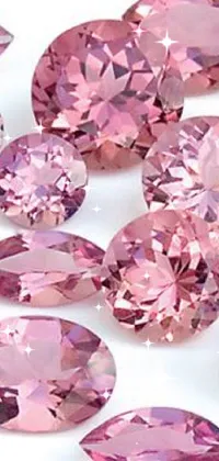 This mobile live wallpaper features pink diamonds against a white background