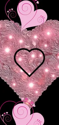 Looking for a captivating live wallpaper for your phone? Look no further than this beautiful image, featuring a close-up view of a heart bedazzled with an array of charming pink details