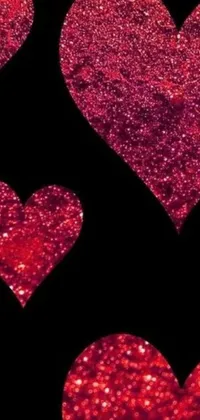 This stunning live wallpaper showcases dazzling red glitter hearts that glisten against a black backdrop
