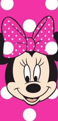 Get the ultimate Minnie Mouse phone wallpaper featuring the iconic Disney character's face on a bright pink background