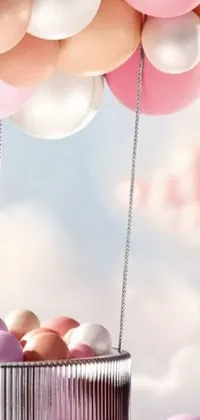 This phone live wallpaper features a lovely basket filled with delightful pink and white balloons