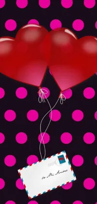 This live phone wallpaper displays two red balloons with a card attached, surrounded by pink hearts in the background