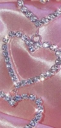 Looking for an elegant and eye-catching live wallpaper for your phone? This heart-shaped necklace on a soft pink cloth is the perfect choice! The stunning fractal details and diamond elements give a unique y2k aesthetic, and the close-up shot brings out all of the intricate textures and details
