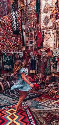Display a stunning live wallpaper on your phone featuring an elegant woman posing in a room filled with vibrant rugs