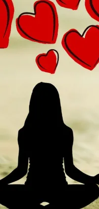 This live phone wallpaper showcases a serene silhouette image of a woman seated in a lotus position with heart-shaped figures floating above her head
