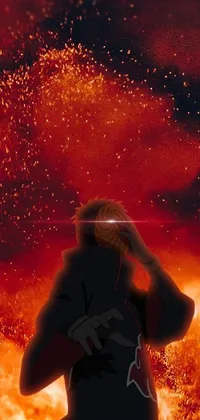 This phone live wallpaper portrays a man standing in front of a blazing fire, in the profile of an anime ninja