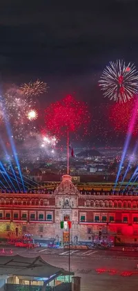 This live wallpaper depicts a stunning fireworks display against the backdrop of a grand building