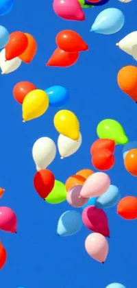 This phone live wallpaper features a group of colorful balloons floating on a bright sky background