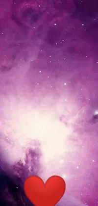 This stunning phone live wallpaper showcases a vivid and eye-catching red heart perched atop a deep purple galaxy that appears to twinkle with stars and cosmic wonders