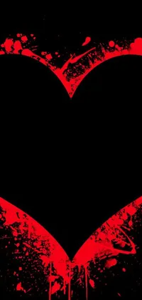 This mobile wallpaper showcases a heart-shaped object covered in red paint splatters set against a black backdrop also speckled with red