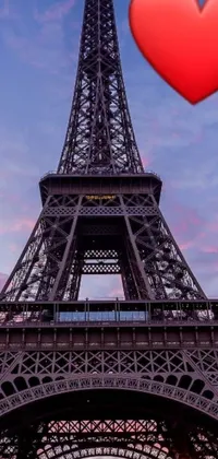 This phone live wallpaper showcases a stunning red heart positioned in front of the amazing Eiffel Tower, set in beautiful Paris, France