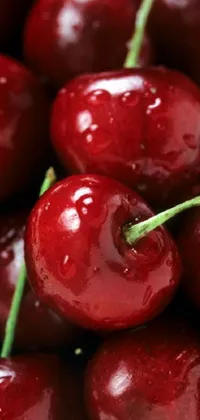This phone live wallpaper features a pile of shiny, red cherries sitting atop one another