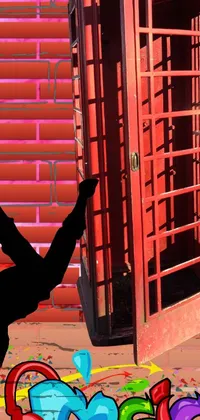 This live phone wallpaper features a dynamic and colorful image of a person performing a handstand in front of a red phone booth