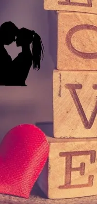 The Love Live Wallpaper captures the sweetest moment between a couple with a wooden block that spells 'love