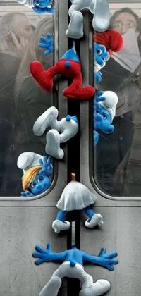 This phone live wallpaper features colorful digital art of several Smurfs hanging from the side of a train, offering an exciting and playful visual design for your device