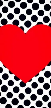 Looking for an eye-catching phone live wallpaper? Check out this bold red heart on black and white polka dot background! This playful and energetic design is perfect for those who love creative expression and dynamic aesthetics