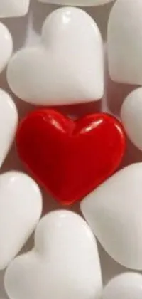 This phone live wallpaper features a stunning red heart surrounded by many white hearts, picture, photo pinterest, candies, and symbols of love