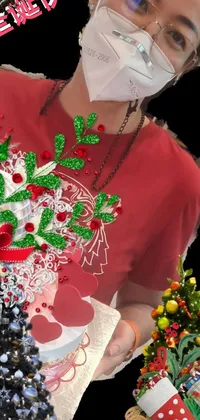 This captivating live wallpaper features a vibrant depiction of a woman wearing a red shirt, holding a festive Christmas tree against a colorful backdrop