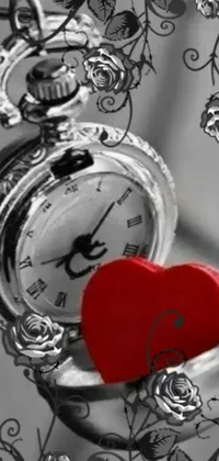 This delightful live phone wallpaper features a red heart inside a pocket watch, complete with black and white and red colors