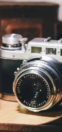 Transform your mobile phone into a vintage photography scene with this stunning live wallpaper