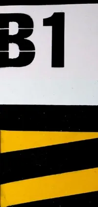 This phone live wallpaper displays a vibrant yellow and black sign featuring a bold graphic of a bee