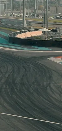 Experience the rush of speed and adrenaline with this exciting live wallpaper! Featuring a dynamic race track with curves galore, this wallpaper captures the thrill and excitement of motorcycle racing