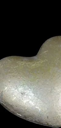 This live wallpaper features two heart-shaped rocks sitting closely together, forming an abstract sculpture that's both beautiful and captivating