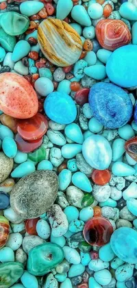 This live phone wallpaper showcases a stunning close-up of various rocks and stones in vibrant colors such as blue-green, light pink, deep purple, and more