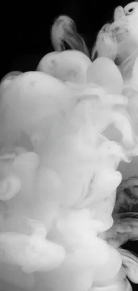 This live phone wallpaper showcases a stunning black and white image of an underwater cloud of smoke, sourced from Pexels