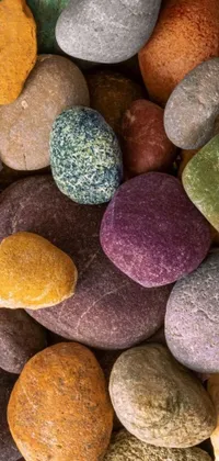 This live wallpaper is a close-up photo of a colorful pile of rocks, featuring natural gems in varying sizes and textures