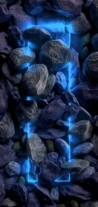 This phone live wallpaper features a mesmerizing blue light at the center of a pile of rocks