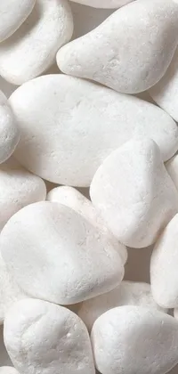 This phone live wallpaper features an up-close view of a pile of smooth white rocks with rounded shapes, giving your device an elegant and natural look