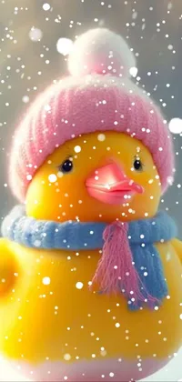 Transform your phone into a winter wonderland with this adorable live wallpaper featuring a cute yellow duck wearing a warm pink hat and scarf
